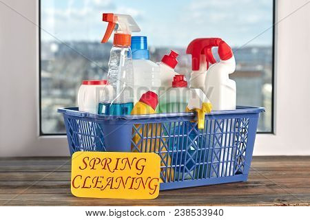 Basket With House Cleaning Items. Cleaning Equipment In Blue Basket On Window Sill. Spring Cleaning 