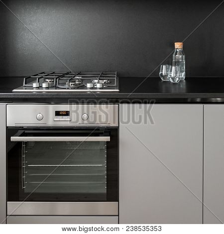 Kitchen Cabinet And Black Backsplash