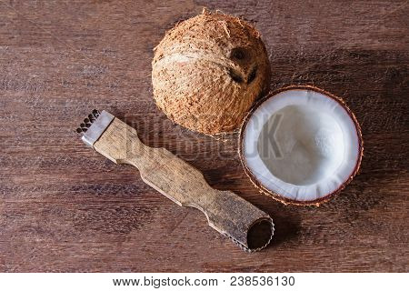 The Tool For Scraping The Coconut Meat Small On Wood Floor. Top View