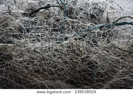 Textures And Backgrounds: Disorganized Tangle Of A Fishing Net Standing In The Harbor.