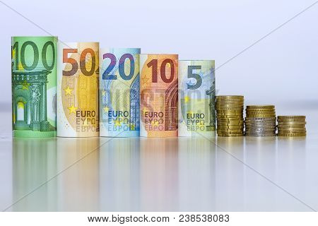 Straight Row Of Accurately Rolled Hundred, Fifty, Twenty, Ten And Five New Paper Euro Banknotes And 
