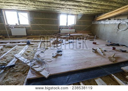 Big Spacious Light Empty Attic Room Under Construction And Renovation. Mansard Floor And Ceiling Ins