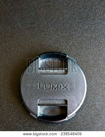 Bishkek, Kyrgyzstan - 24 February, 2018: Close Up Logo Of Black Cap Lumix On Black Table