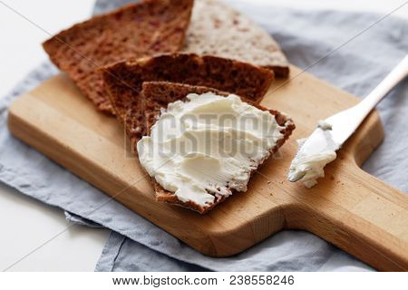 Sandwich with cream cheese on a slice of Finnish bread Reikaleipa