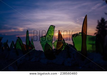 Broken Colorful Bottle Glass At Sunset On Background