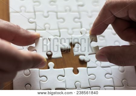 Two Hands Are Connecting Jigsaw, Teamwork Concept.