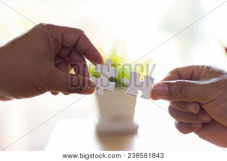 Two Hands Are Connecting Jigsaw, Teamwork Concept.