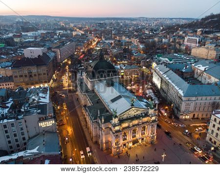 Aerial View Of City In Night Time. Streets In Car Lights.
