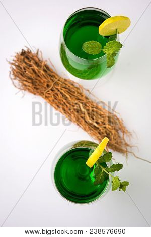 Green Khus Sharbat Or Vetiver Grass Extract Or Chrysopogon Zizanioides Served In Tall Glass With Min