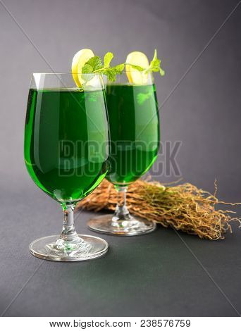 Green Khus Sharbat Or Vetiver Grass Extract Or Chrysopogon Zizanioides Served In Tall Glass With Min