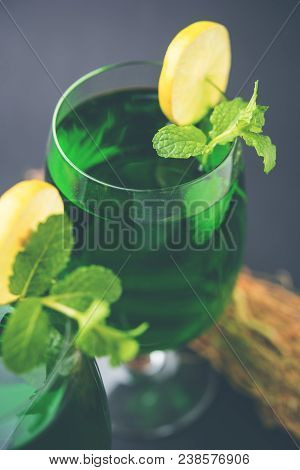 Green Khus Sharbat Or Vetiver Grass Extract Or Chrysopogon Zizanioides Served In Tall Glass With Min