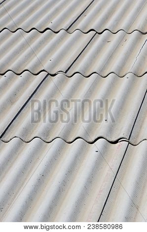A Fragment Of A Gray Slate Roof Of An Old Sample Made Of Asbestos Material