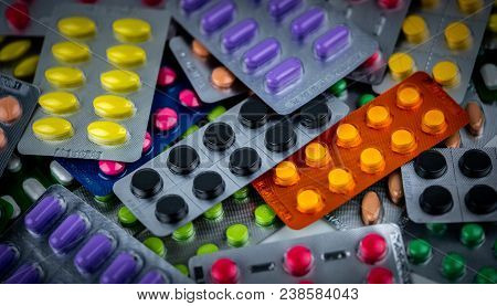 Pile Of Colorful Tablets Pill In Blister Packaging. Pharmaceutical Industry Concept. Pharmacy Drugst