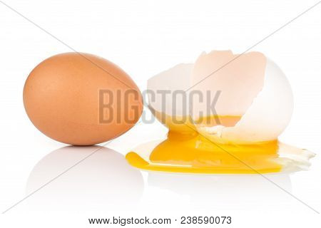 Brown Chicken Egg And Cracked One With Dripping Out Yolk Isolated On White Background