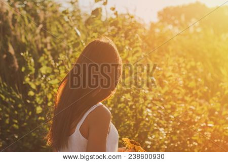 Beautiful Woman Holding Sunflower In Forest Background