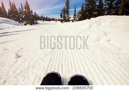 Close-up Of Skiing On Background Of Descent From Mountain Along Route