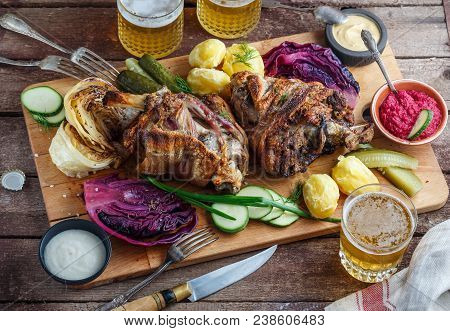 Roasted Pork Knuckle Eisbein With Beer And Assorted Snacks.