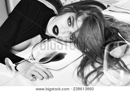 Sensual Elegant Glamour Drunk Woman With Beautiful Hair Lying On Table With Glass And Poored Red Win