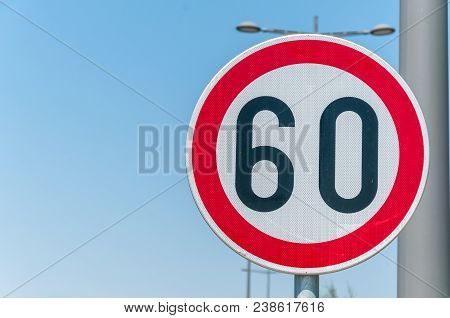 Traffic Speed Limit Sign For Restriction On 60 Kilometers Or Miles Per Hour With Blue Sky Background