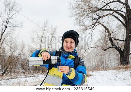 Young Gyu With Thermos On Snow Forest Background.