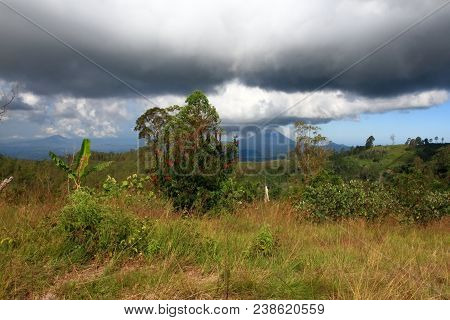 Mountain Concept, Sky With Heavy Clouds. Indonesia, Island Flores,  Volcano Gunung Inerie At Back