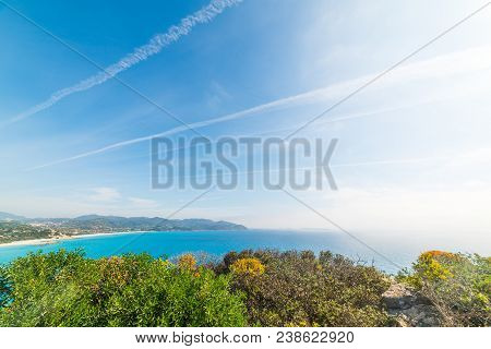 Green Plants And Blue Sea In Porto Giunco Coastline, Villasimius. Sardinia, Italy