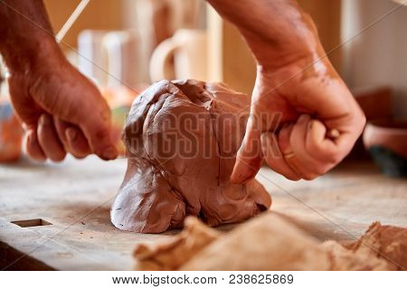 Hands Of Male Potter Molding A Clay In Pottery Workshop, Close-up, Selective Focus. Creative Work Pr