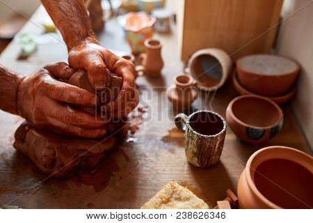 Hands Of Male Potter Molding A Clay In Pottery Workshop, Close-up, Selective Focus. Creative Work Pr