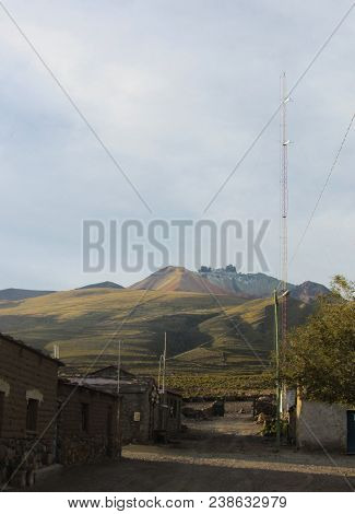 Perspective From A Dirt Road Of The Small Village Of Chatahuana, With The Tunupa Volcano In The Back