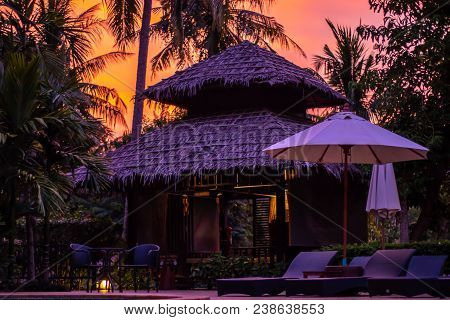 A Pool Side Traditional Thai Style Bungalow At A Luxury Resort In Krabi, Thailand At Golden Hour Sun