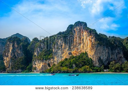 A Thai Long-tail Boat And A Motorboat Racing Along Beautiful Limestone Mountains Near Railay Beach I