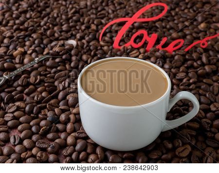 Cup Of Coffee With Milk On Background Of Coffee Beans