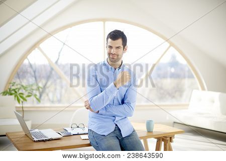 Smiling Young Businessman In The Office
