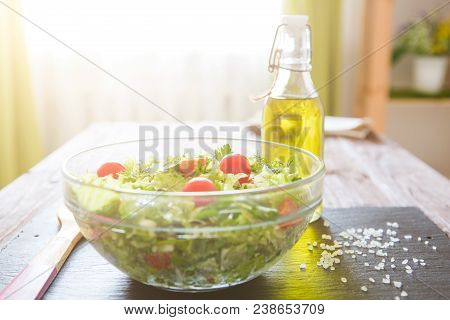 Salad With Tomatoes In Glassy Bowl On Wooden Table.