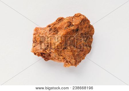 Quartzite Ferruginous On White Background. Macro Photo Of Natural Mineral Rock Sample