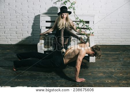 Retro Woman Put Legs On Back Of Muscular Man. Muscular Man Training Sport At Pretty Young Girl. Coup