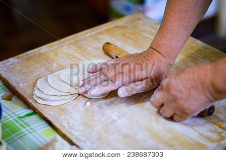 Chinese Family Make Dumpling Skins On Wooden Board