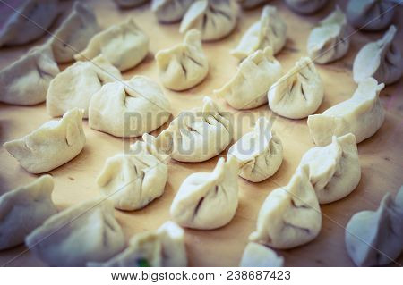 Chinese Uncooked Dumplings Placed On Wooden Board.  The Dumplings, Called Jiaozi In Chinese, Is A Po