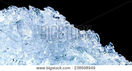 Pile Of Crushed Ice Cubes On Dark Background With Copy Space. Crushed Ice Cubes Foreground For Bever