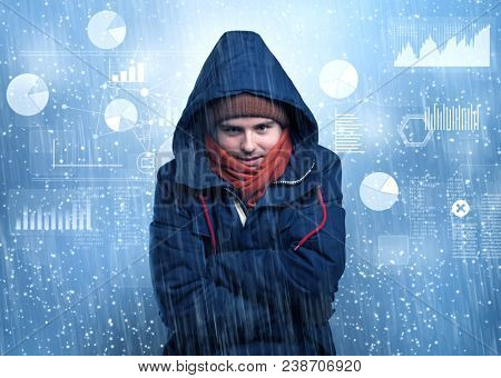 Young businessman shivering with graphs, reports and chart concept
