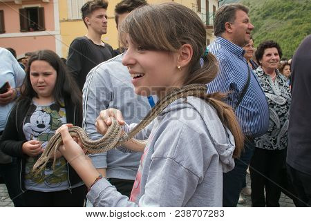Cocullo, Italy - May 1, 2018: Portrait Of Pretty Child With Snake At The Feast Of Saint Dominic In T