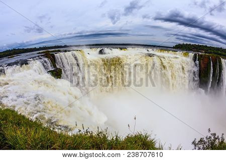 The most full-flowing waterfall in the world. The Devil's throat /Garganta del Diablo/ in grandiose waterfalls Iguazu in the rainy season. Concept of active and ecological tourism