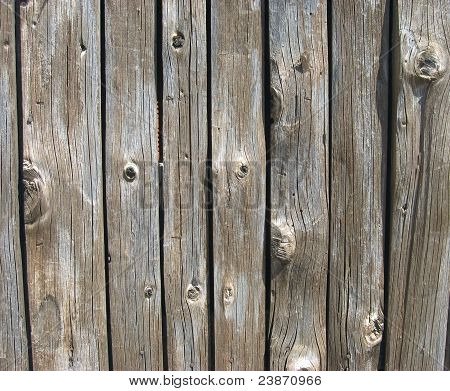 Textura skutečné hnědé starožitných dřevěných panelů s uzly a obilí