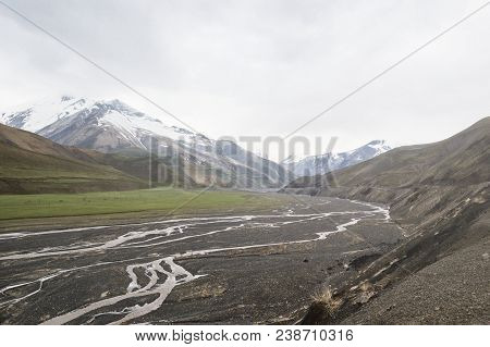 View Of The Snow-covered Caucasus Mountains And River