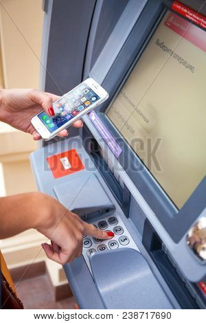 24 November 2016: RUSSIA, MOSCOW, GUM:  A woman is hand using keypad atm machine  