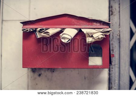 An overfull old post box