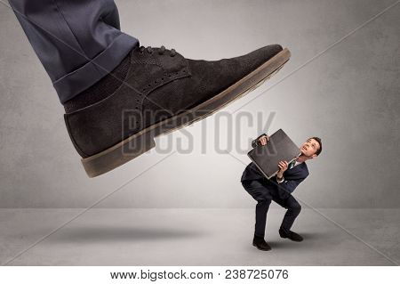 Young businessman illustrated inconsiderable by being trampled