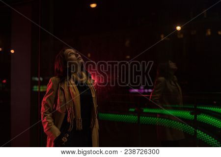 Girl Brunette Near In The Shopwindow On The Night City Street In A Cold Time