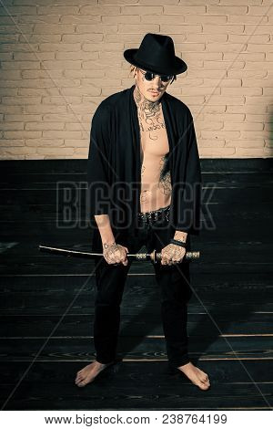 Harakiri, Suicide Ritual. Samurai, Buddhist Concept. Man With Sword Standing On Wooden Floor Barefoo