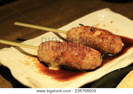 Tsukune Filled With Cheese Serve With Special Sauce On White Plate